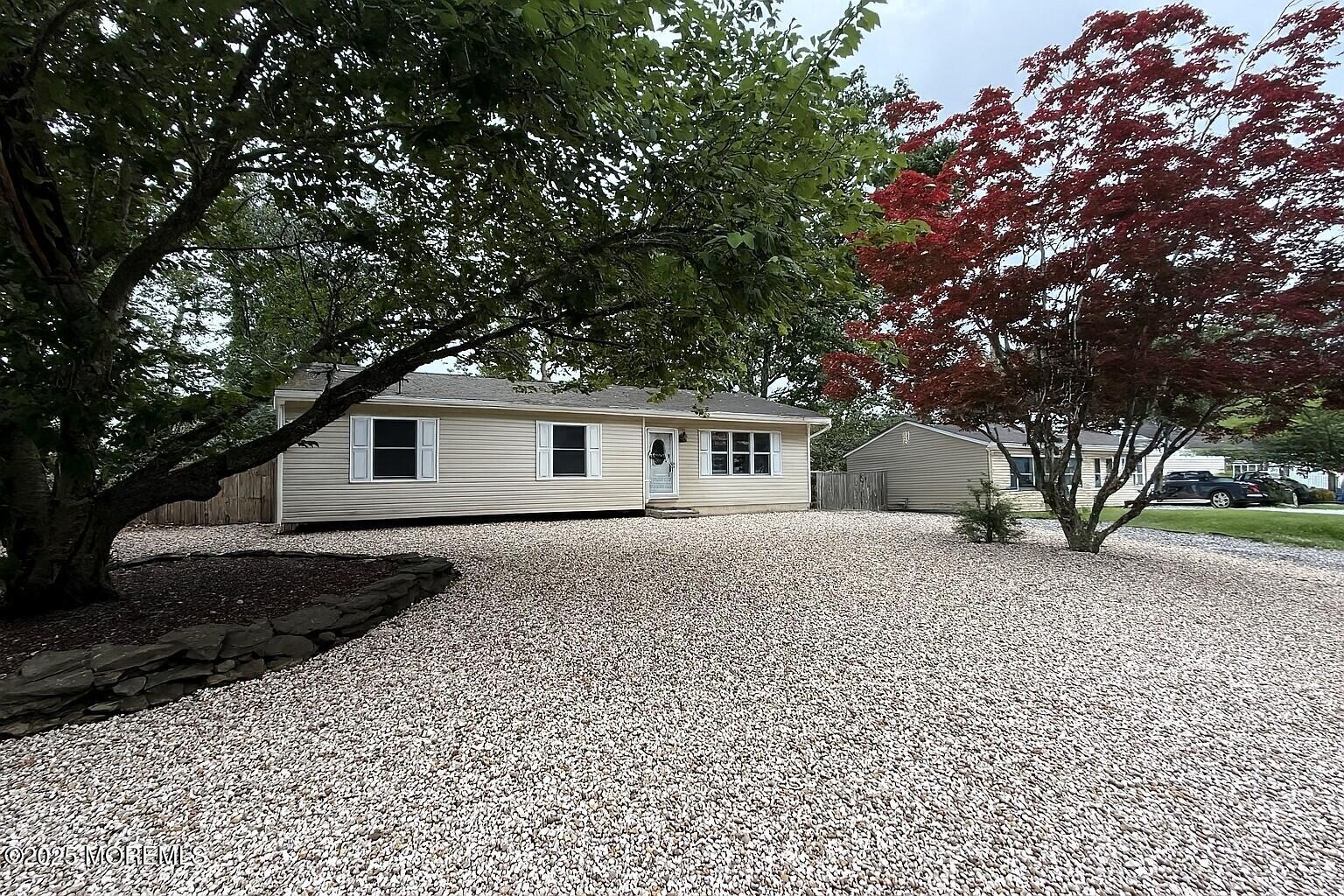168 Stowaway Road Manahawkin, NJ 08050 - Photo 1 of 15 a front view of a house with a garden