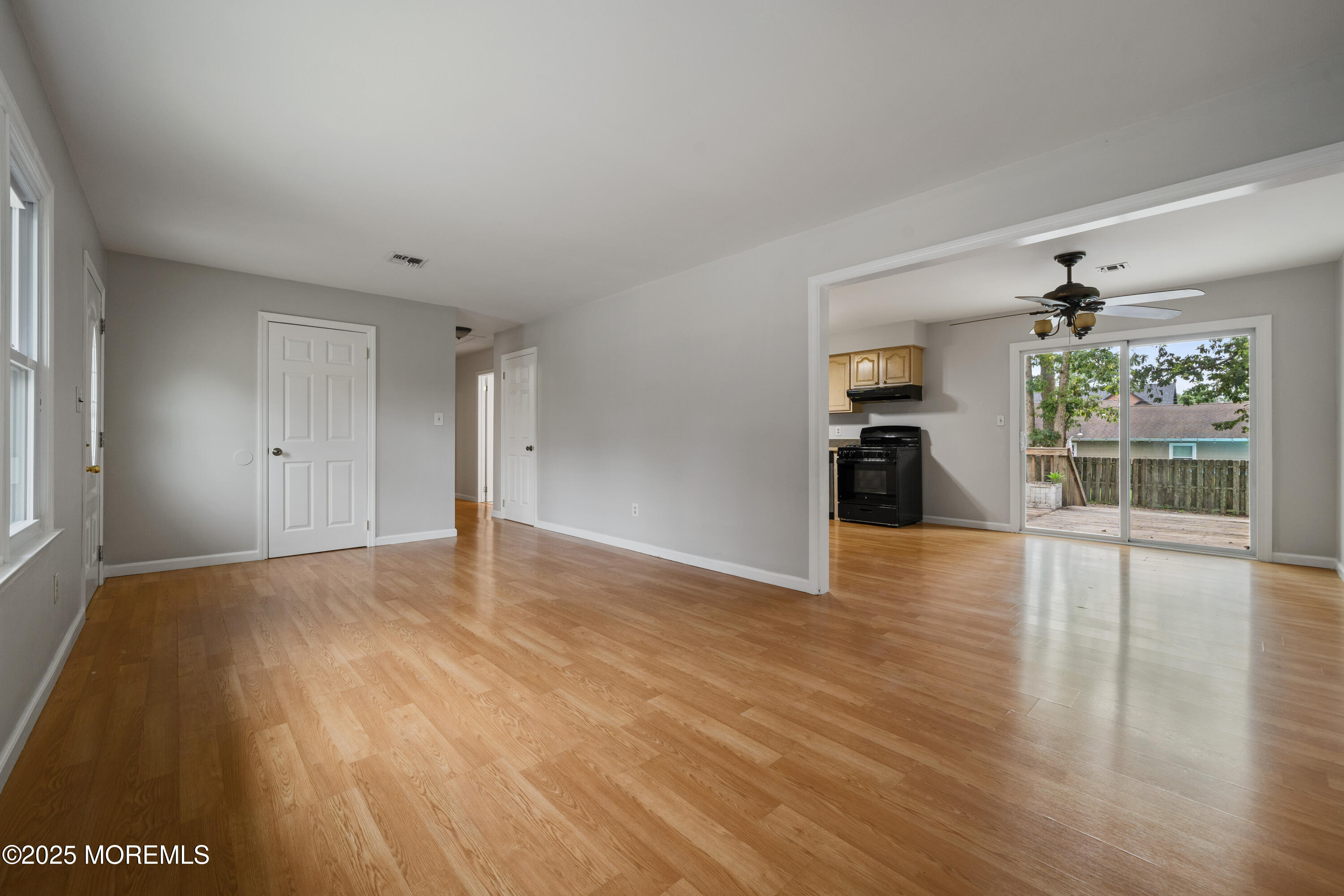 168 Stowaway Road Manahawkin, NJ 08050 - Photo 4 of 15 a view of an empty room with wooden floor and a window