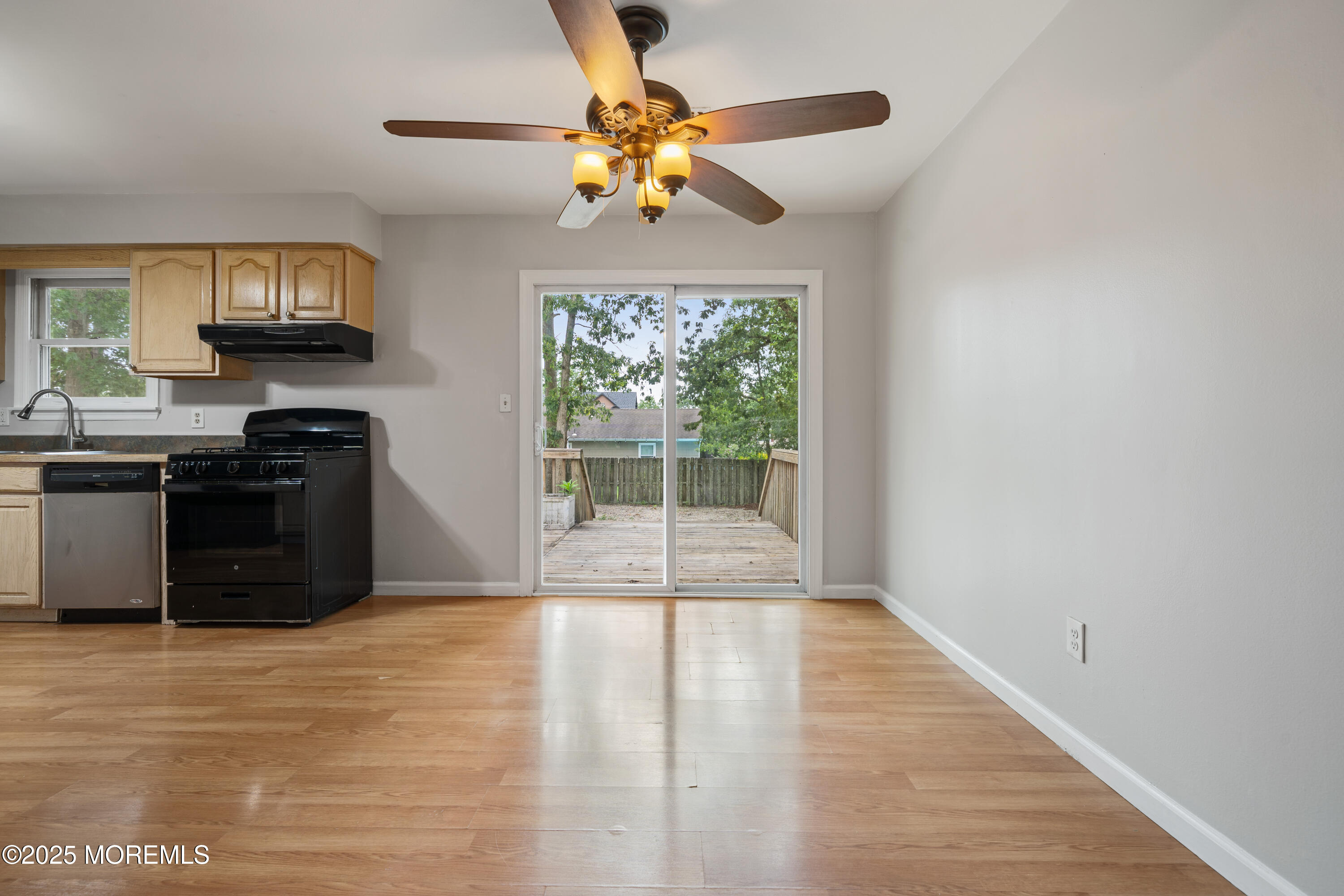 168 Stowaway Road Manahawkin, NJ 08050 - Photo 5 of 15 a view of a kitchen with a stove cabinets and a floor to ceiling window