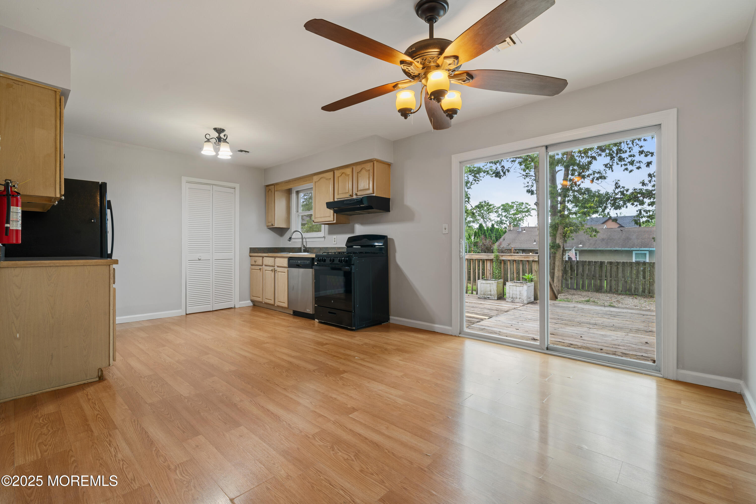 168 Stowaway Road Manahawkin, NJ 08050 - Photo 6 of 15 a view of a kitchen with a stove wooden floor and a ceiling fan