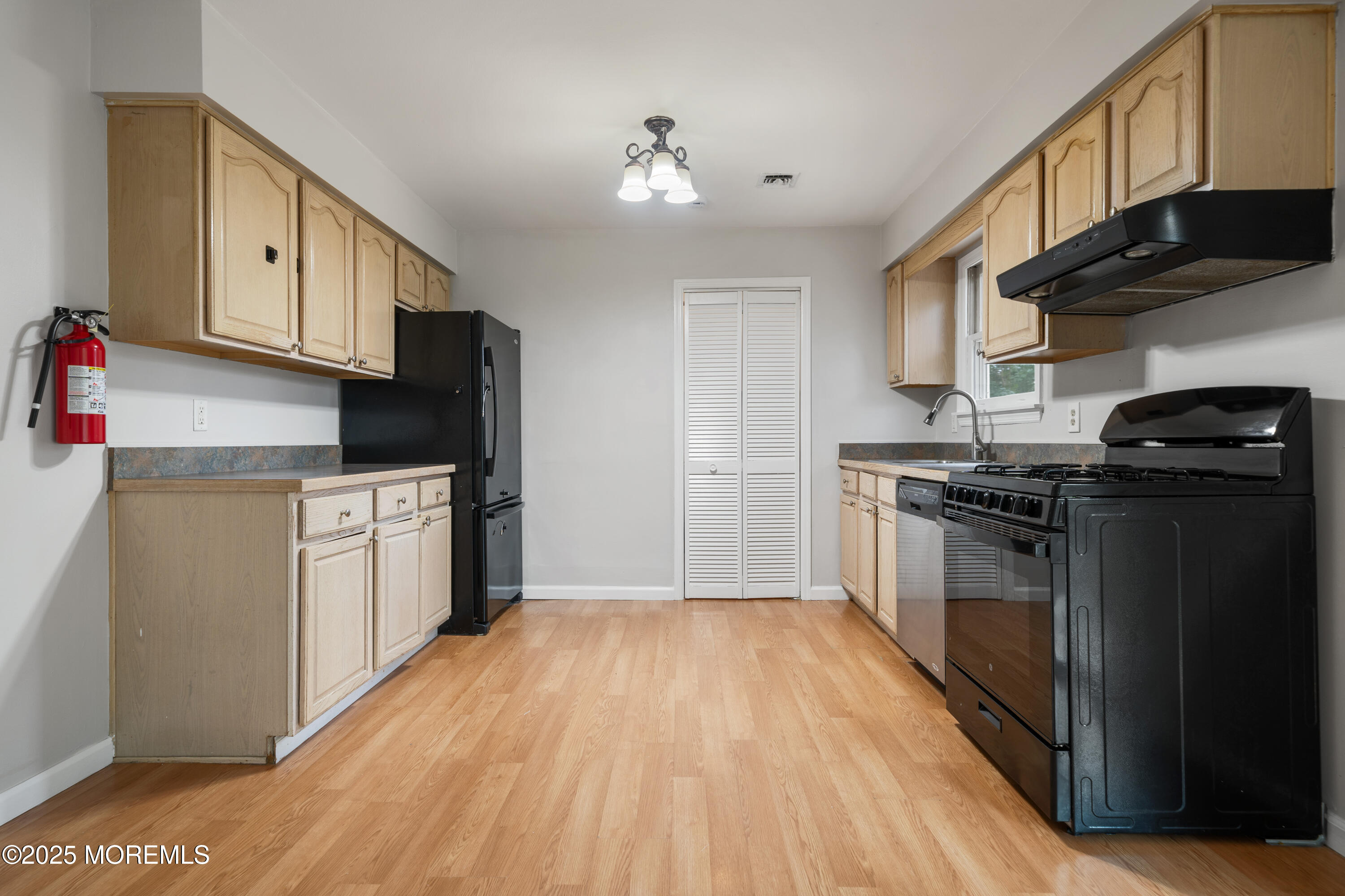 168 Stowaway Road Manahawkin, NJ 08050 - Photo 7 of 15 a kitchen with granite countertop wooden floors stainless steel appliances and cabinets