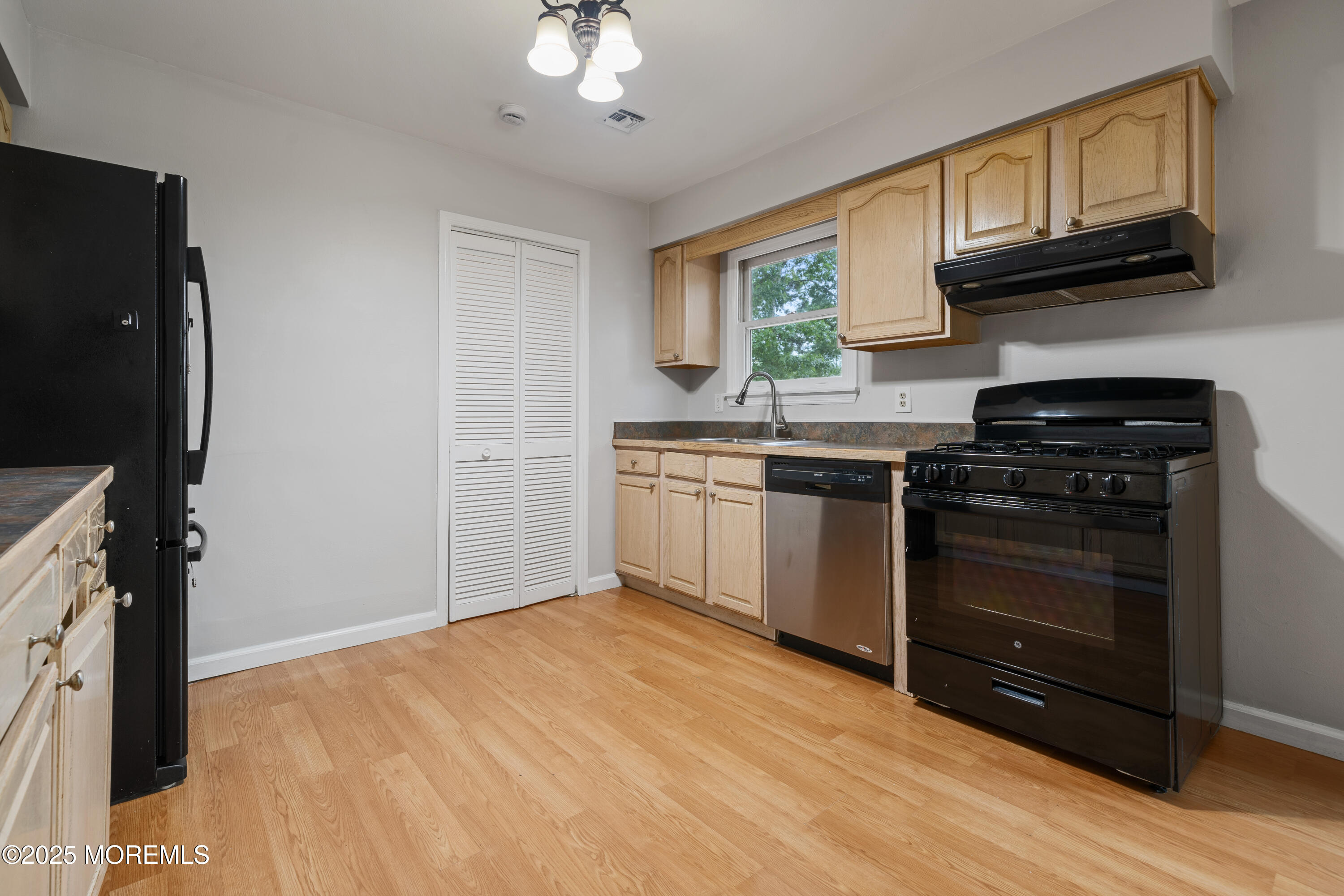 168 Stowaway Road Manahawkin, NJ 08050 - Photo 8 of 15 a kitchen with stainless steel appliances granite countertop a stove a sink and a microwave