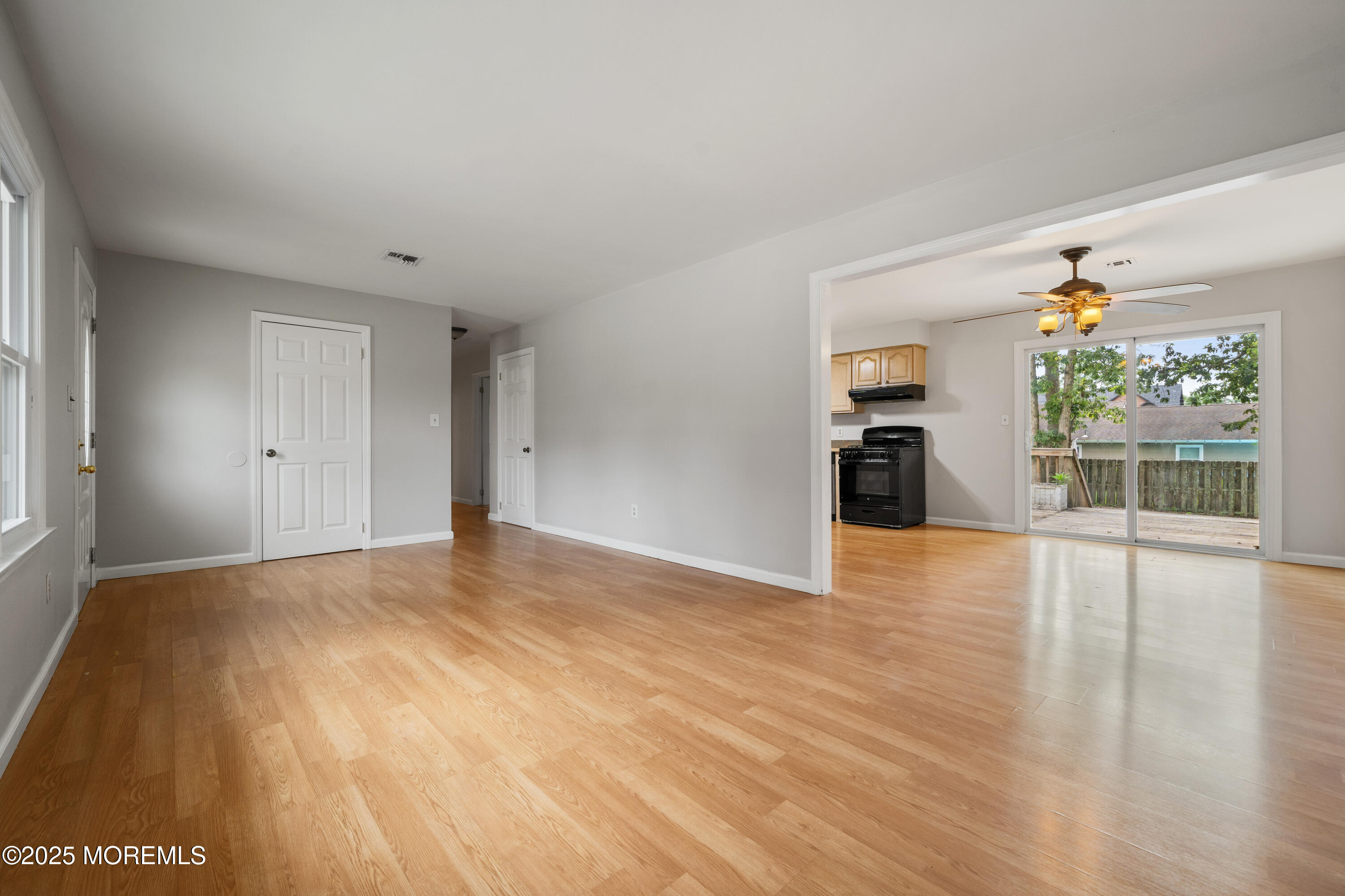 168 Stowaway Road Manahawkin, NJ 08050 - Photo 10 of 15 a view of an empty room with a window and wooden floor