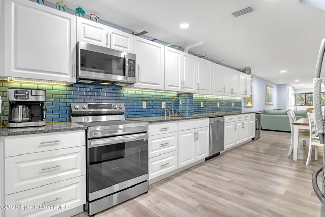 a kitchen with stainless steel appliances a refrigerator stove microwave and cabinets