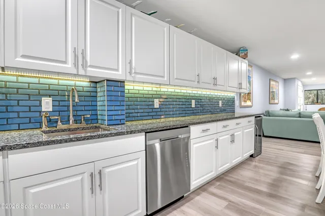 a kitchen with stainless steel appliances a refrigerator and a stove top oven