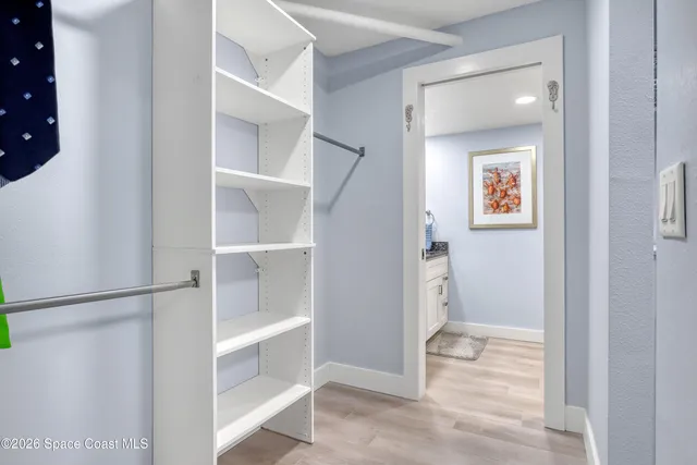 a bathroom with a granite countertop double vanity sink and a mirror