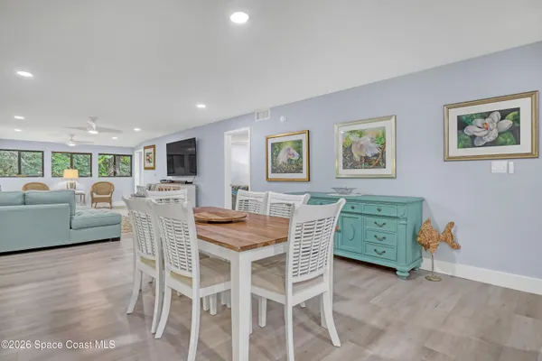 a view of a dining room with furniture and wooden floor