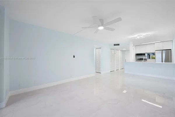 a view of kitchen and empty room with kitchen