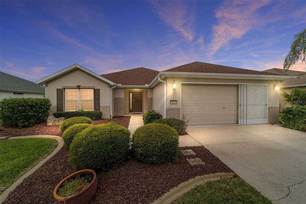 a front view of a house with garden