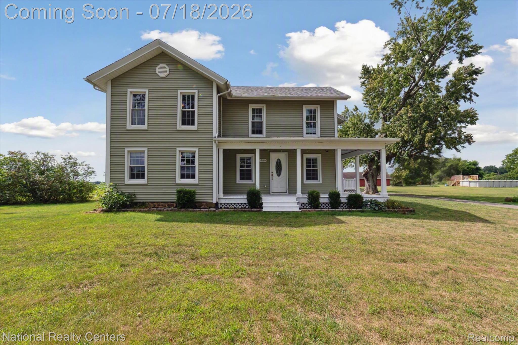 9589 Clinton Macon Road Tecumseh, MI 49286 - Photo 2 of 48 Two-story residence featuring light green horizontal siding and a covered porch with white columns