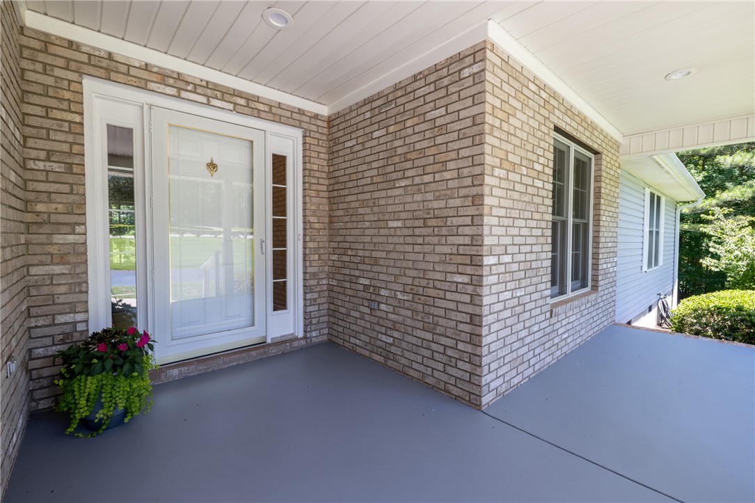 429 Burns Mill Road West Union, SC 29696 - Photo 48 of 49 A welcoming brick exterior frames the entry, offering a glimpse of the serene outdoor landscape.