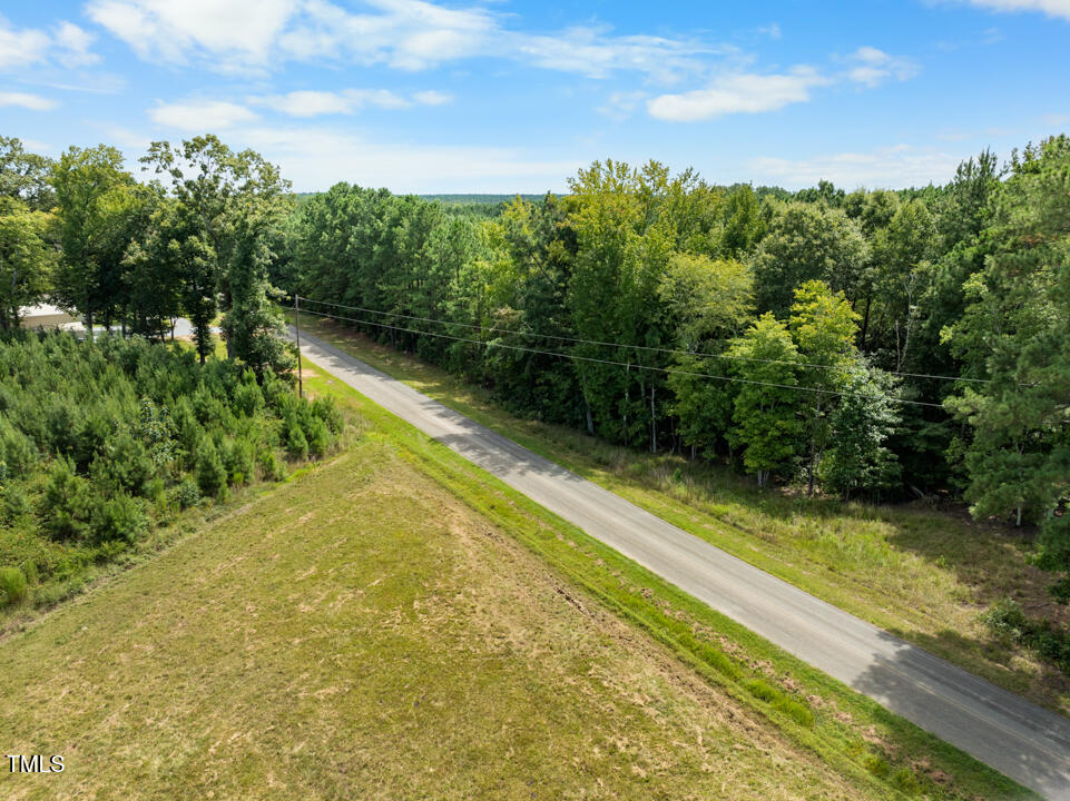 4104 Wilson Town Road Oxford, NC 27565 - Photo 3 of 7 a view of a yard with plants and a bench