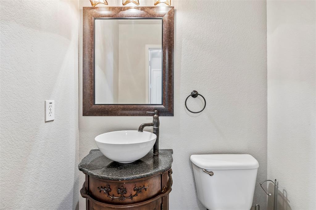 3931 Alpha Way Midlothian, TX 76065 - Photo 22 of 33 a bathroom with a toilet a sink and mirror