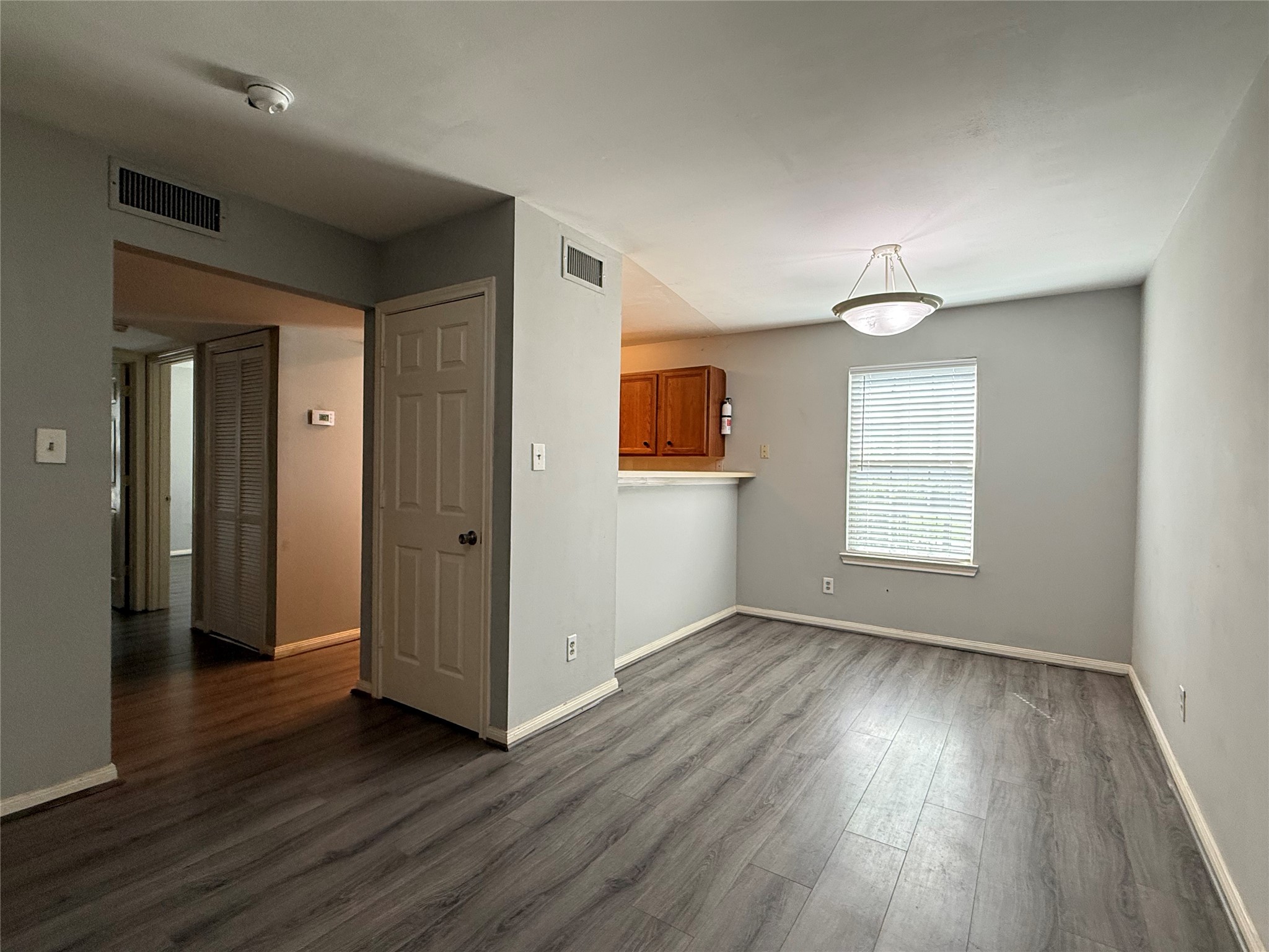 304 Dell Court, Unit 6 Houston, TX 77009 - Photo 14 of 14 an empty room with wooden floor and windows