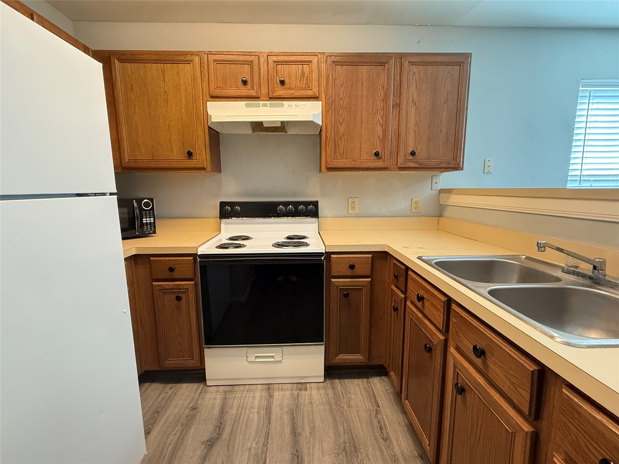 304 Dell Court, Unit 6 Houston, TX 77009 - Photo 5 of 14 a kitchen with a stove sink and cabinets