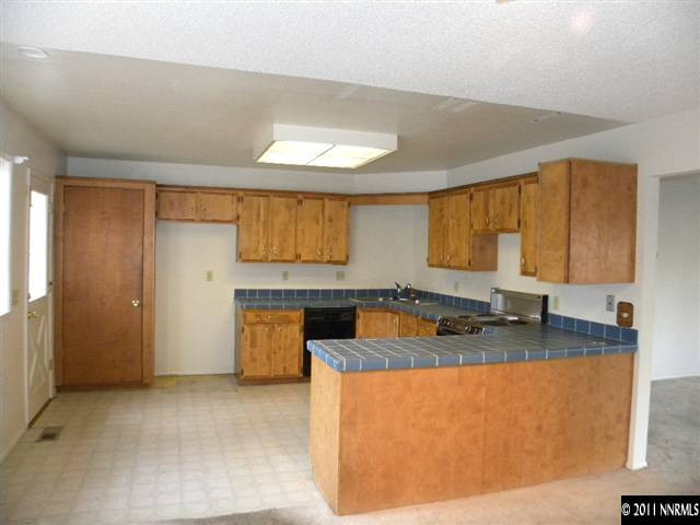 825 Bell Street Reno, NV 89503 - Photo 5 of 13 a kitchen with stainless steel appliances granite countertop a sink a stove and a refrigerator
