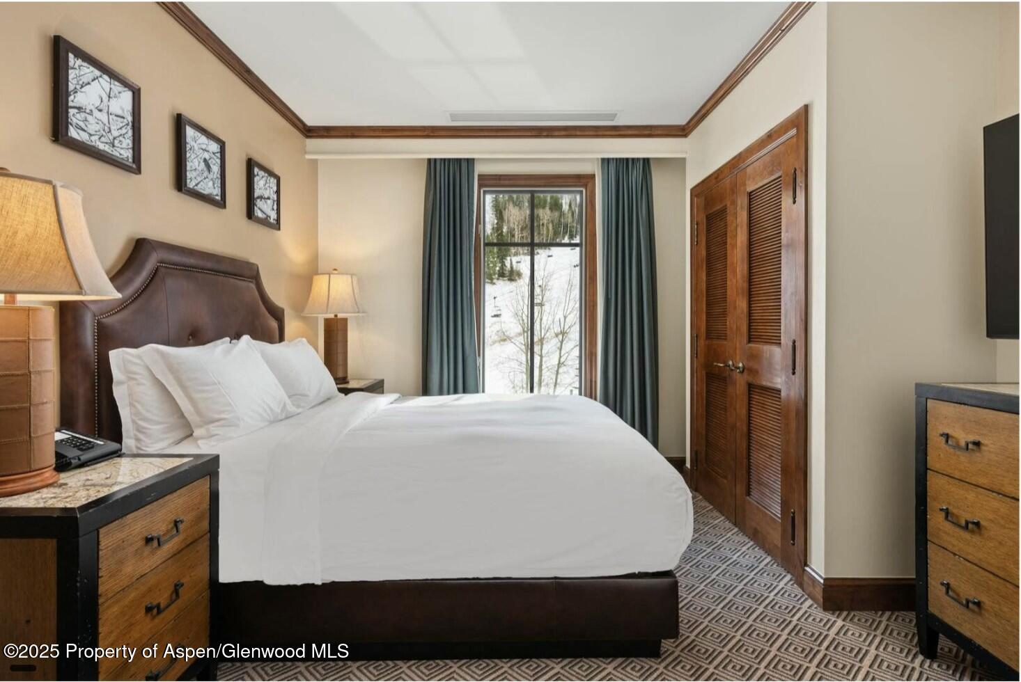 75 Prospector Road, Unit 83034 Aspen, CO 81611 - Photo 11 of 25 a large bed sitting in a bedroom next to a window