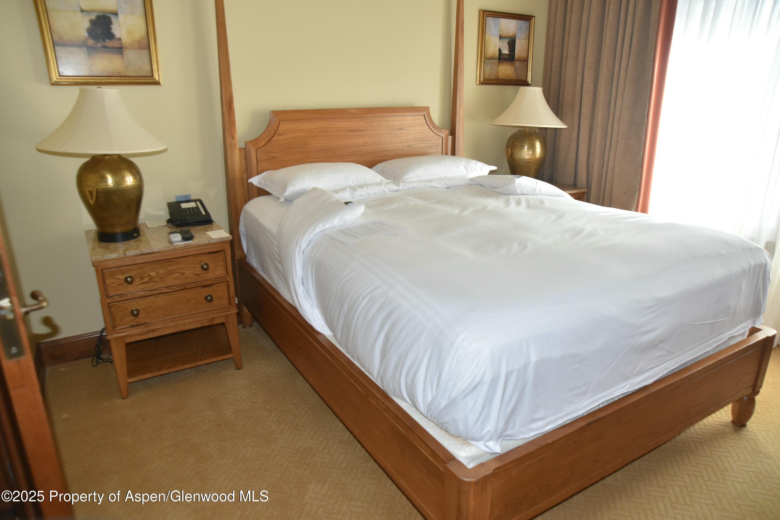 75 Prospector Road, Unit 83034 Aspen, CO 81611 - Photo 14 of 25 a bedroom with a bed and cabinet