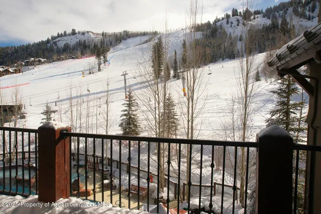 a view of a balcony with wooden fence