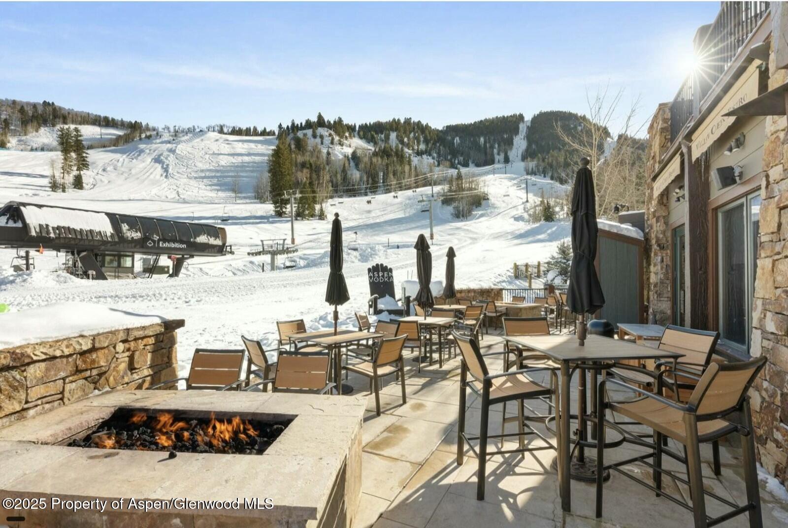 75 Prospector Road, Unit 83034 Aspen, CO 81611 - Photo 19 of 25 a view of a terrace with furniture and outdoor space