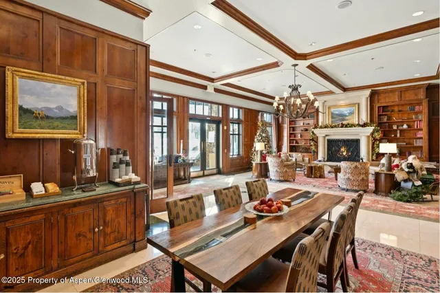 a view of a dining room with furniture a chandelier and wooden floor