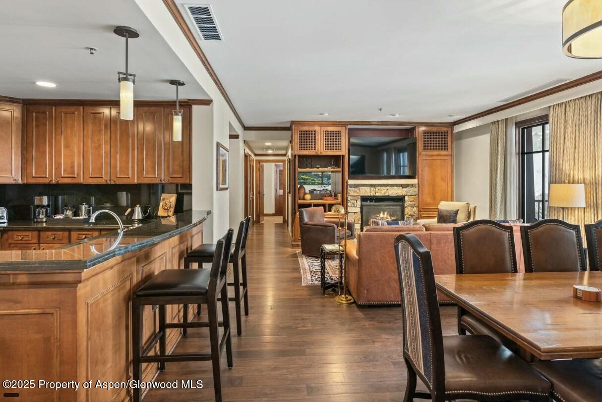75 Prospector Road, Unit 83034 Aspen, CO 81611 - Photo 7 of 25 a view of a dining room with furniture window and wooden floor