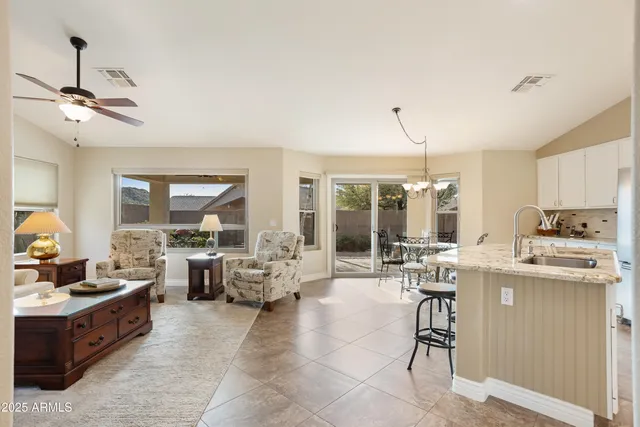 a kitchen with stainless steel appliances kitchen island granite countertop a refrigerator and microwave