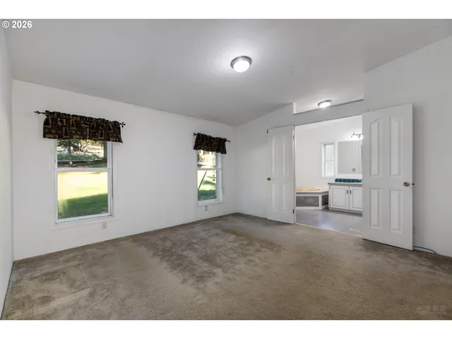 a bathroom with a granite countertop sink a mirror and a shower