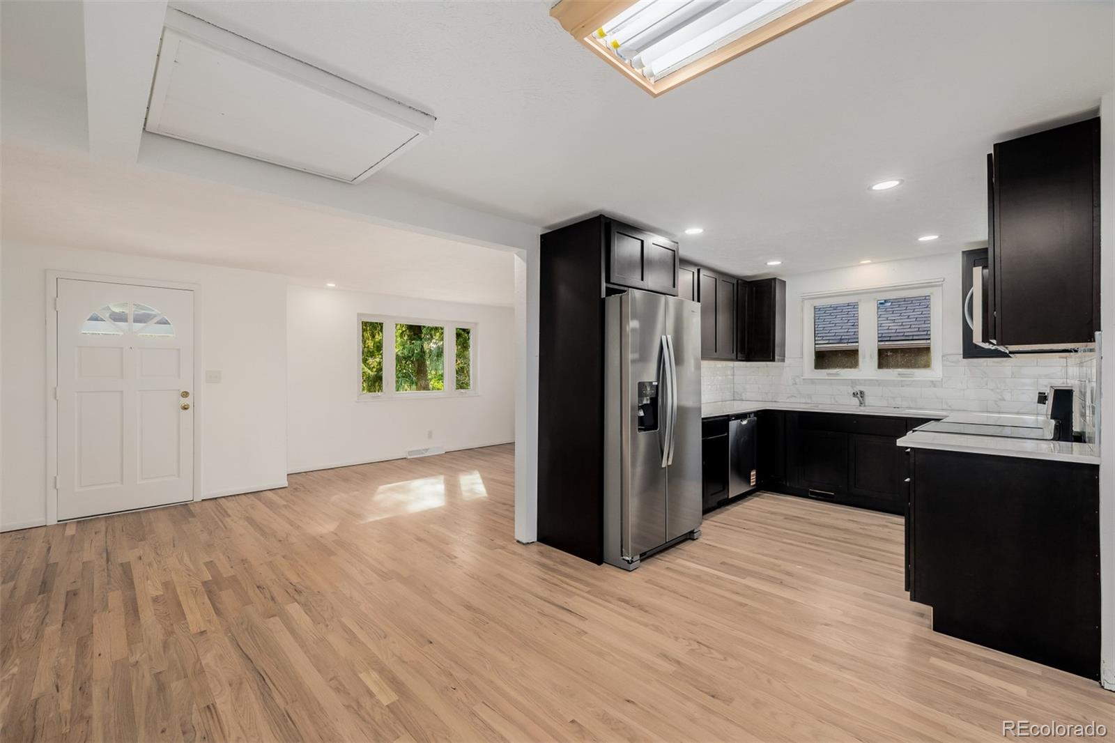 a view of a kitchen with a sink and a refrigerator
