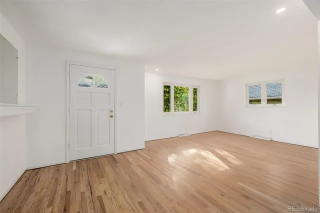an empty room with windows and closet