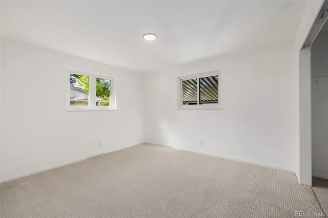 an empty room with windows and wall