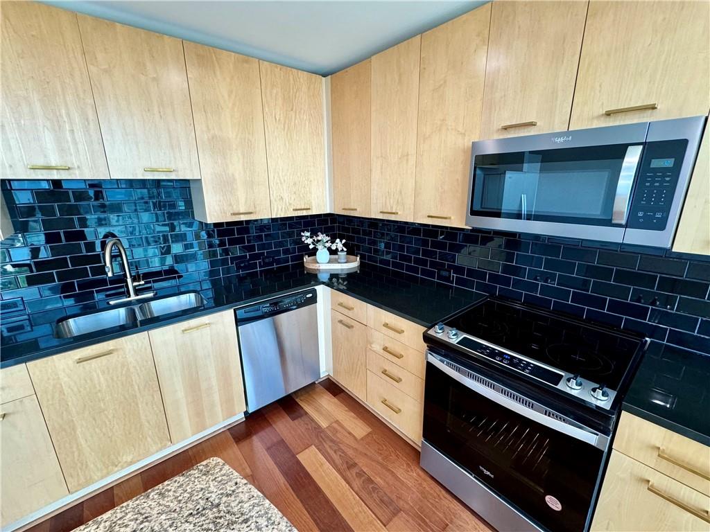 3324 Peachtree Road Northeast, Unit 2307 Atlanta, GA 30326 - Photo 11 of 42 a kitchen with granite countertop a stove a sink and white cabinets