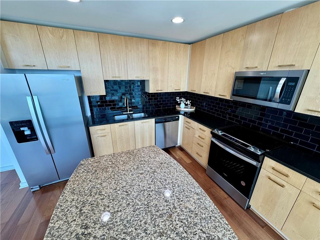 3324 Peachtree Road Northeast, Unit 2307 Atlanta, GA 30326 - Photo 12 of 42 a kitchen with granite countertop a refrigerator stove and sink
