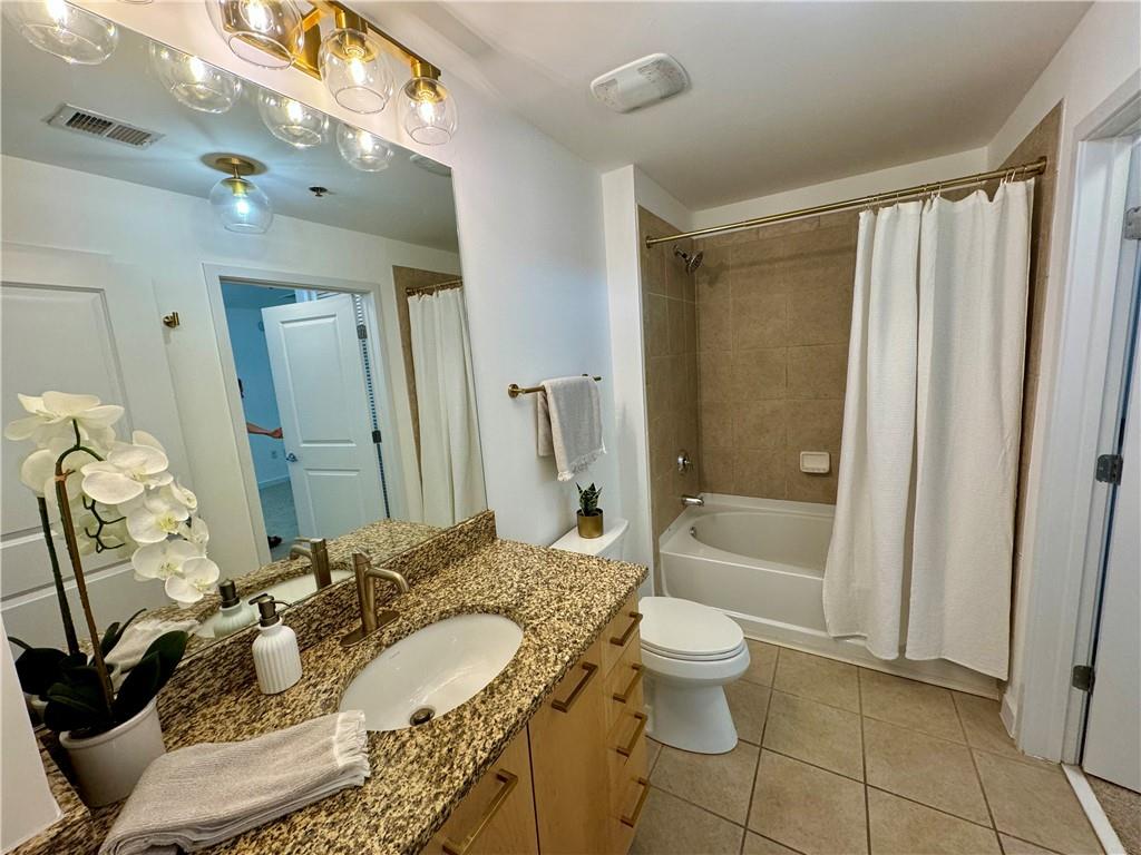 3324 Peachtree Road Northeast, Unit 2307 Atlanta, GA 30326 - Photo 17 of 42 a bathroom with a granite countertop sink a toilet and shower
