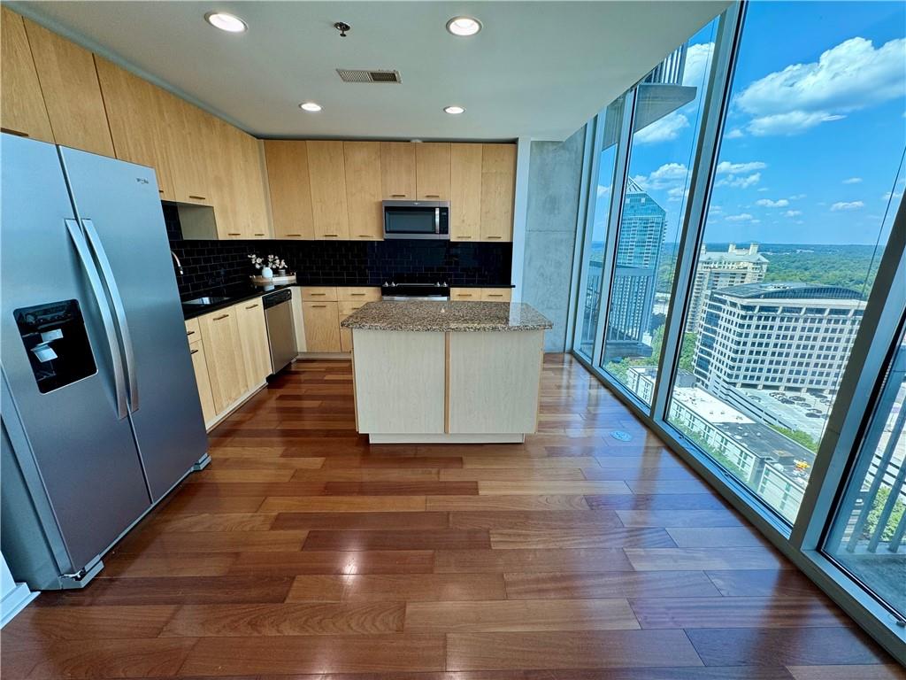 3324 Peachtree Road Northeast, Unit 2307 Atlanta, GA 30326 - Photo 5 of 42 a large kitchen with a large window a refrigerator and a sink
