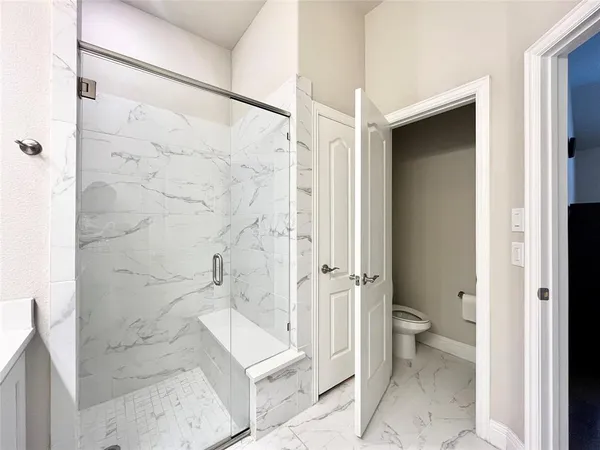 a bathroom with a granite countertop sink mirror and a bathtub