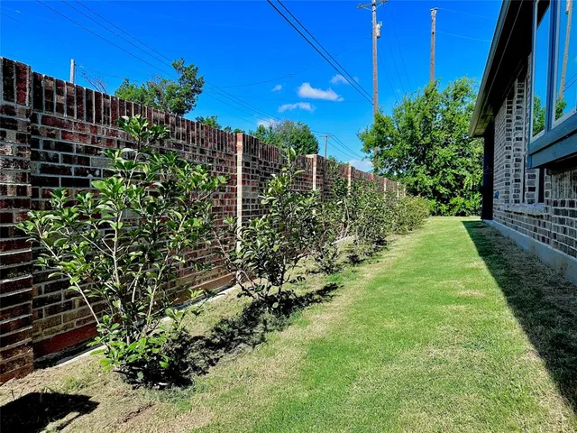 a view of a garden with a house