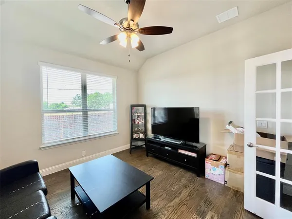 a large white kitchen with wooden floor