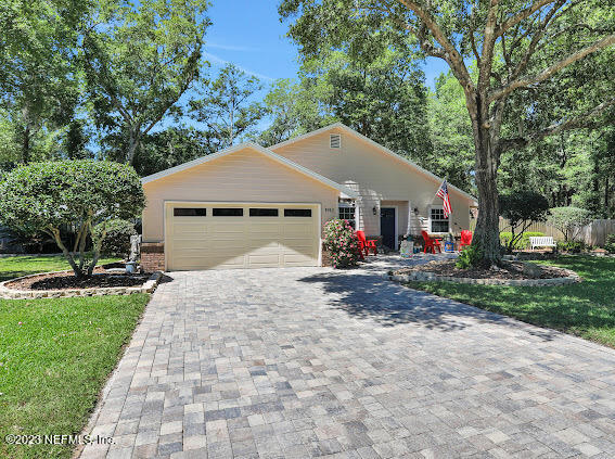 1910 Shadow Ridge Trail Jacksonville, FL 32225 - Photo 1 of 21 a view of a white house with a small yard and large trees