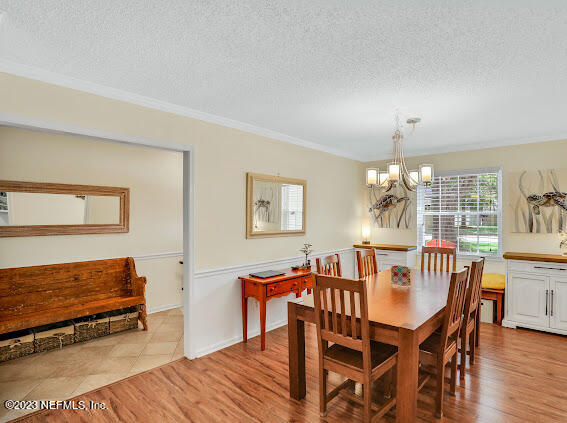 1910 Shadow Ridge Trail Jacksonville, FL 32225 - Photo 12 of 21 a view of a dining room with furniture and wooden floor