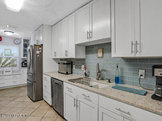 1910 Shadow Ridge Trail Jacksonville, FL 32225 - Photo 18 of 21 a kitchen with stainless steel appliances granite countertop a refrigerator sink and cabinets