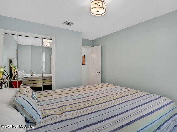 1910 Shadow Ridge Trail Jacksonville, FL 32225 - Photo 19 of 21 a bedroom with a bed and a chandelier