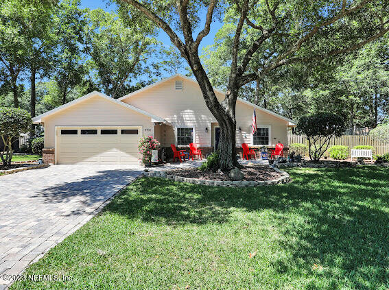 1910 Shadow Ridge Trail Jacksonville, FL 32225 - Photo 3 of 21 a front view of a house with a big yard and a large tree