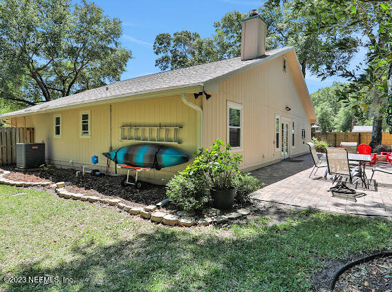 1910 Shadow Ridge Trail Jacksonville, FL 32225 - Photo 6 of 21 a view of a chair and table in backyard