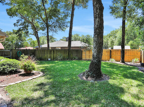 1910 Shadow Ridge Trail Jacksonville, FL 32225 - Photo 7 of 21 a front view of a house with garden and trees