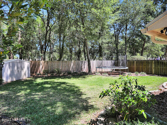 1910 Shadow Ridge Trail Jacksonville, FL 32225 - Photo 10 of 21 a backyard of a house with table and chairs