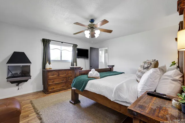 a bedroom with two beds and a chandelier