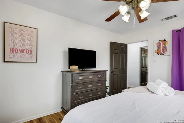 a bedroom with a bed and a flat screen tv