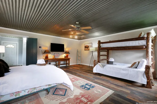 a bedroom with bed and a flat tv screen