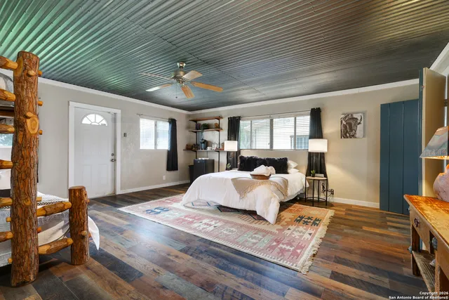 a bedroom with a large bed and a chandelier
